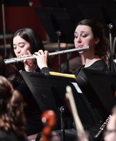 Students playing flute in WVUSO performance